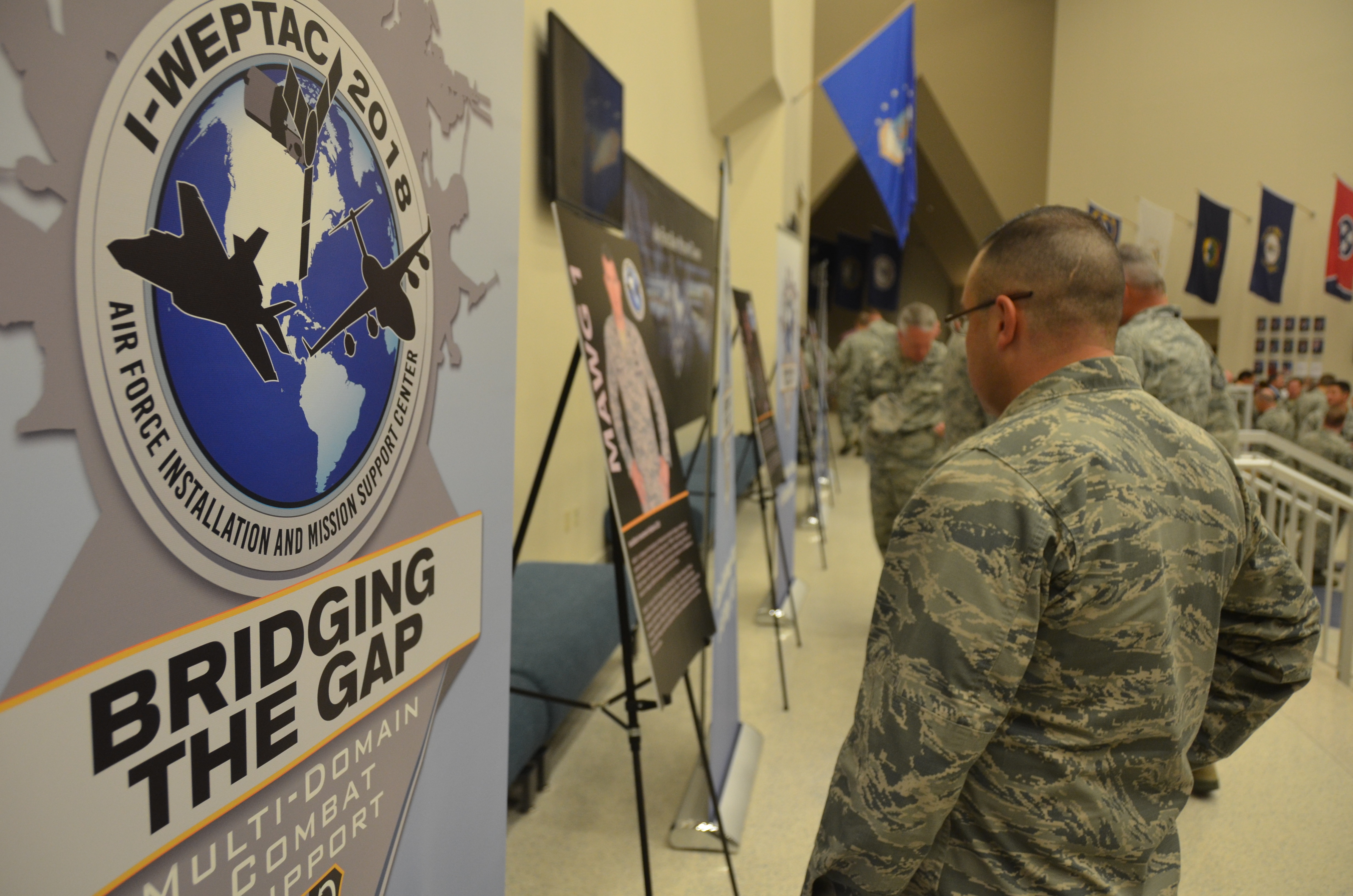 Airman reading posters at an event